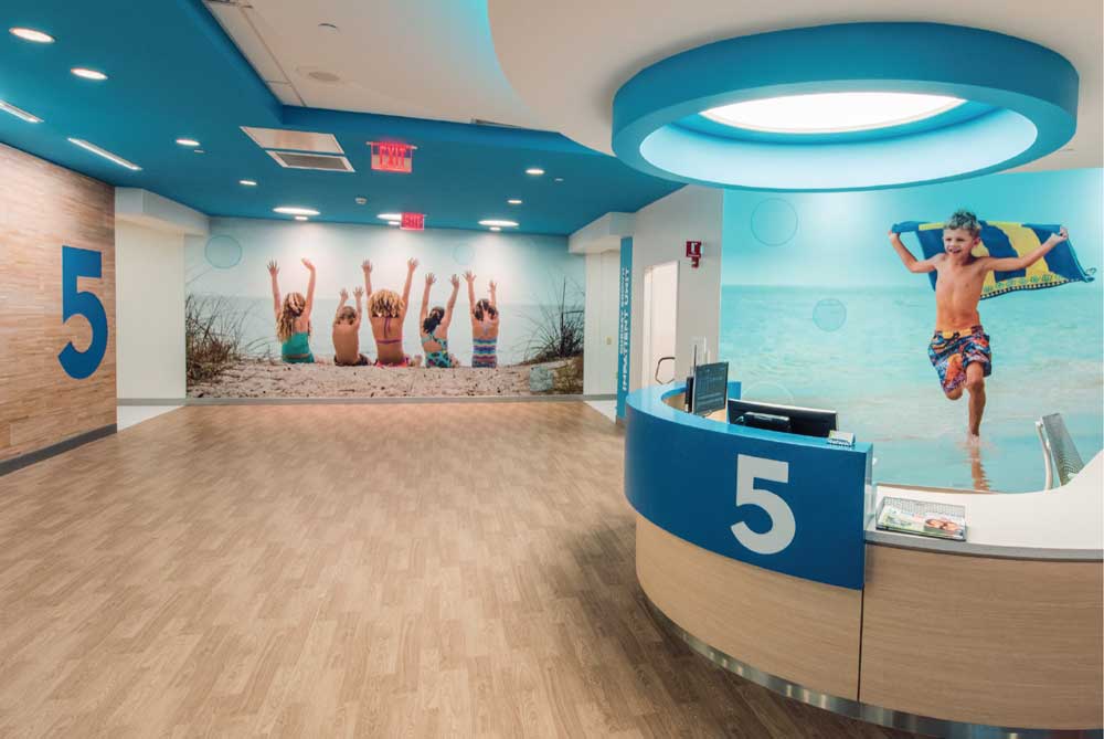 Wall Graphics: Transforming Interiors Light colored wood floors and wall paneling in a medical office.