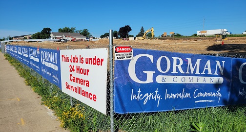 What is a Mesh Banner? 2 Mesh banners hanging on a chain link fence.