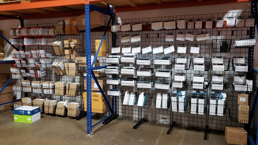 Printer Supplies: Paper, Ink, Toner & Accessories 1 An organized wall of printer supplies and replacement parts.