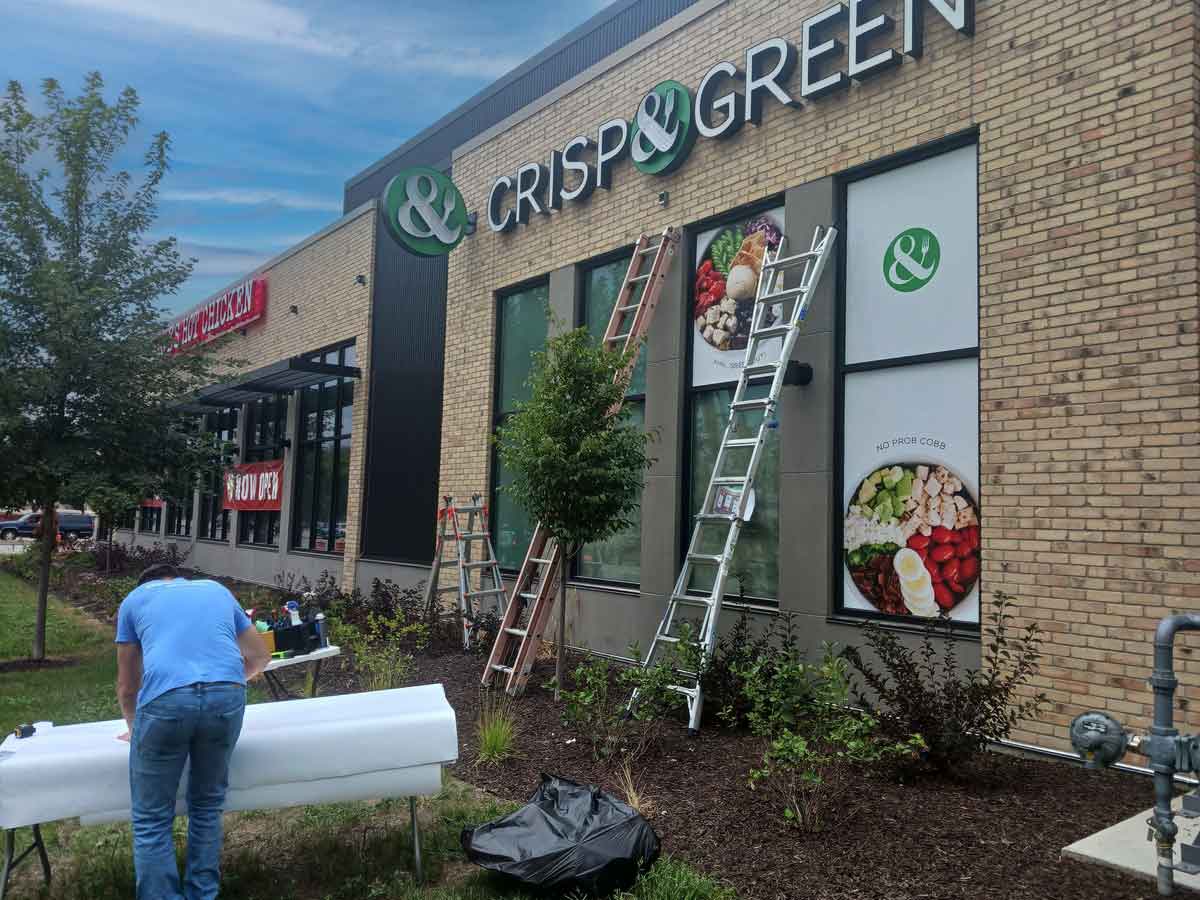 BPI Color team installing exterior window graphics.
