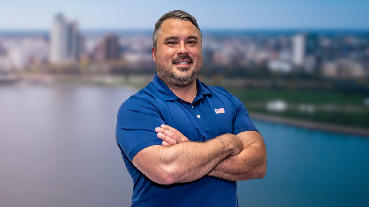 Our Story 10 The owner of BPI Color, Clint Tornow in a blue collard shirt with arms crossed and smiling.