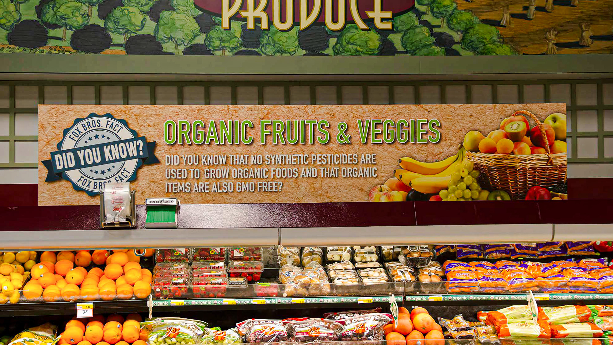 Portfolio Menu 10 Market Signage for Fox Bros organic produce sign above a grocery display, featuring educational messaging about pesticide-free and GMO-free organic fruits and vegetables.
