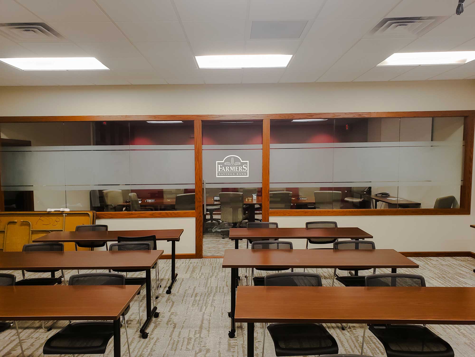 Frosted Window Film applied to the conference room glass at Farmer’s Savings Bank, offering privacy while maintaining a clean, professional appearance.