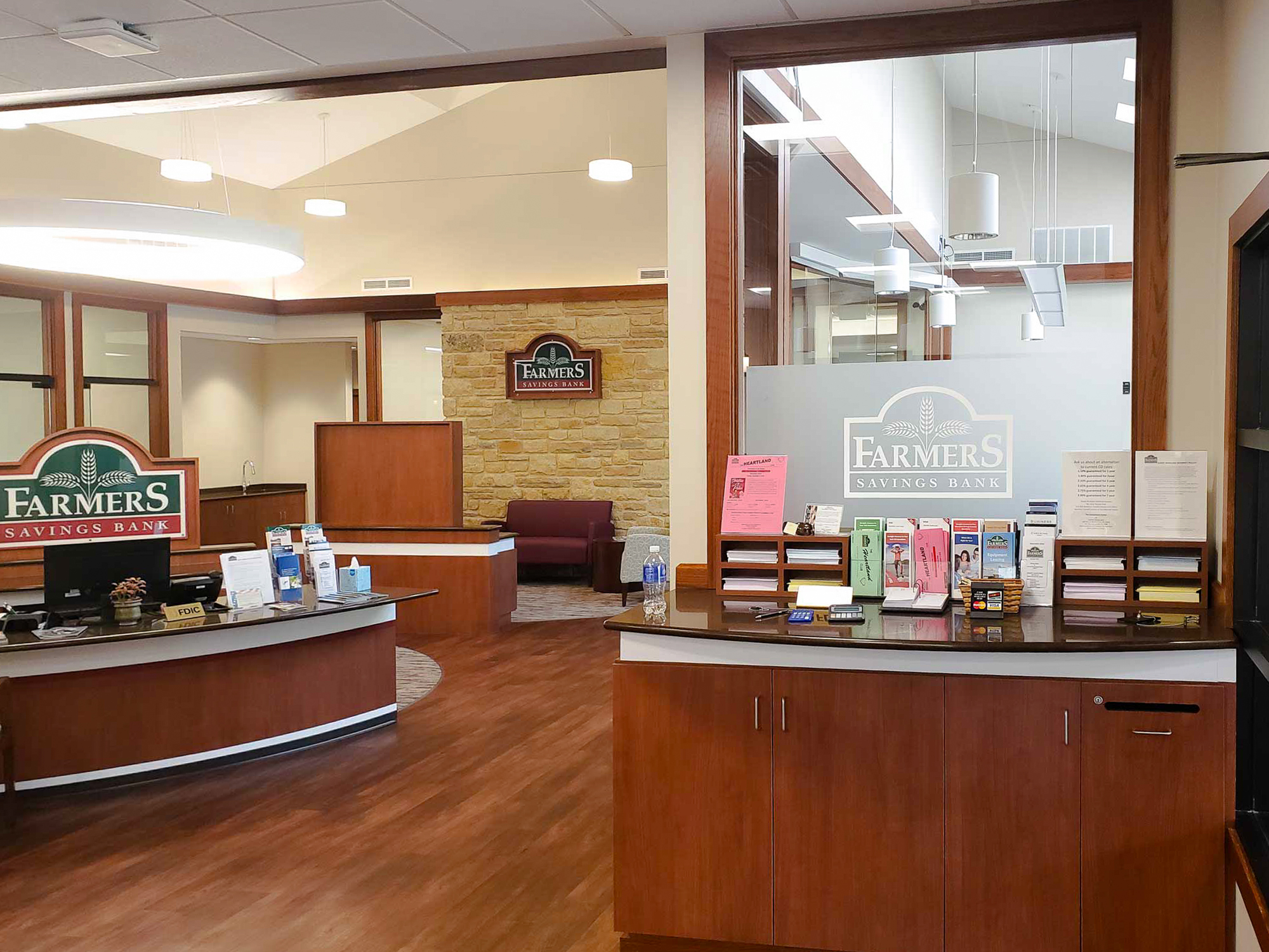 Environmental Graphics featuring branded signage and frosted window film in the lobby of Farmer’s Savings Bank, blending function with visual identity.