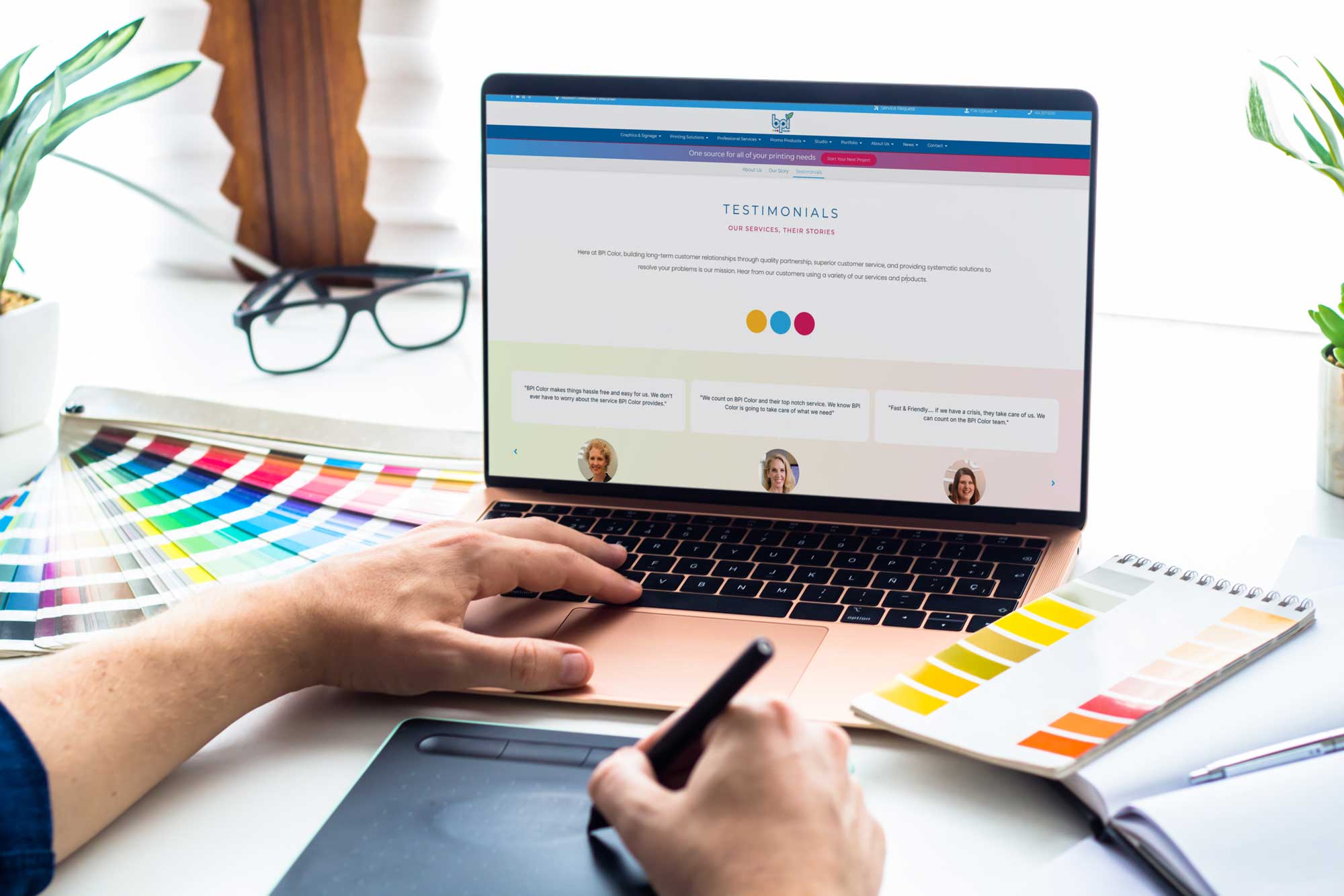 Testimonials: Designer browsing client testimonials on BPI Color’s website, surrounded by color swatches and digital design tools in a bright, modern workspace.