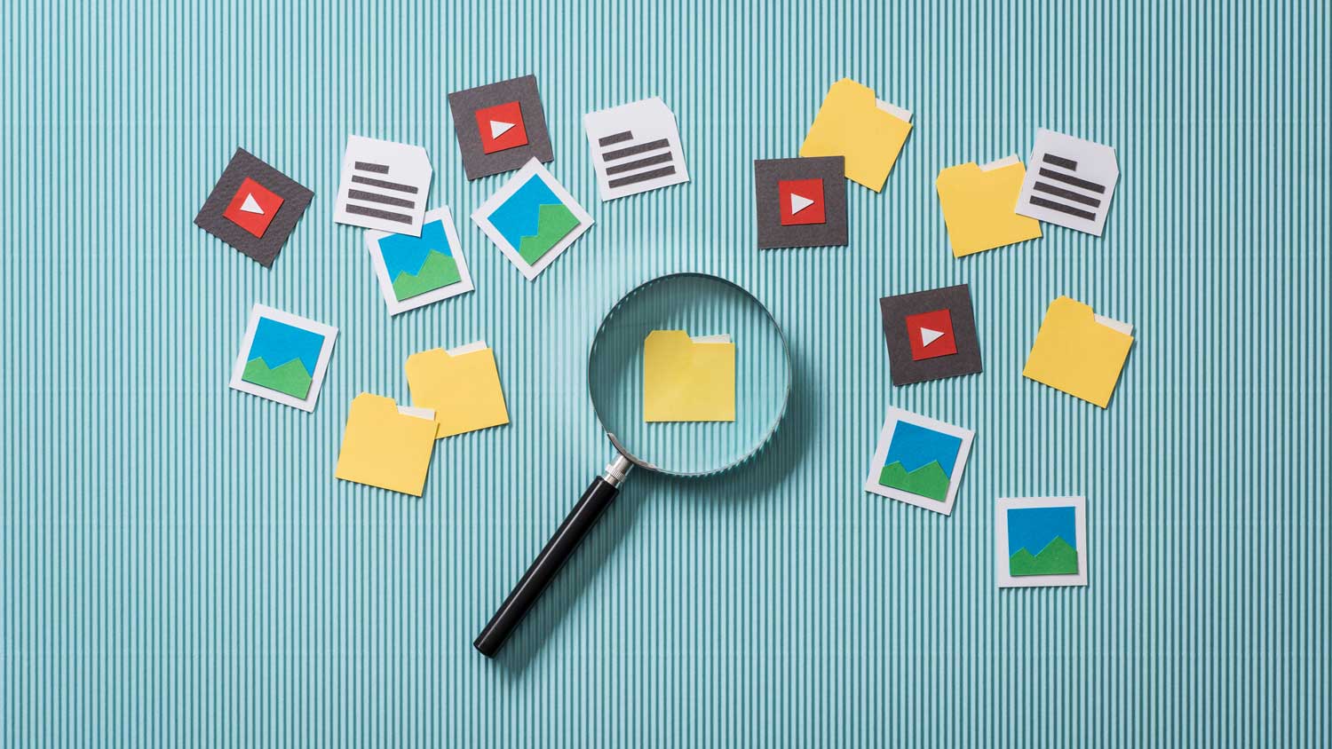 File Asset Management concept image showing a magnifying glass over a folder icon, surrounded by icons representing media files and documents.